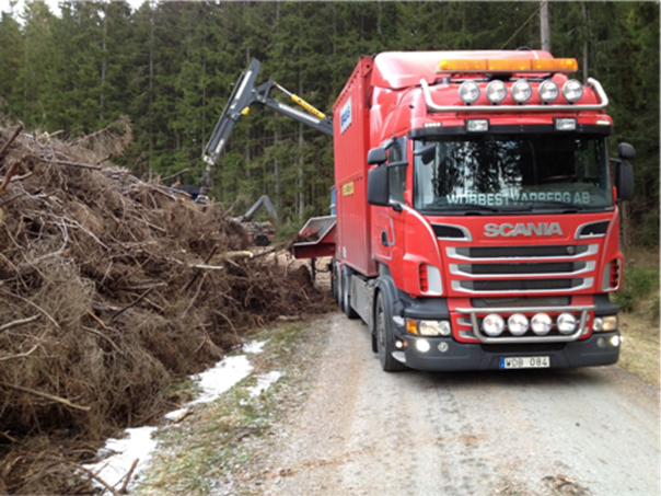 Photograph of branches being taken for biomass processing.